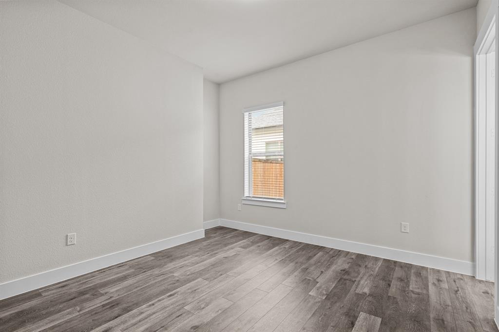 3283 Ganzer Road West, Unit 1105B Denton, TX 76207 - Photo 21 of 37 a view of empty room with wooden floor and fan