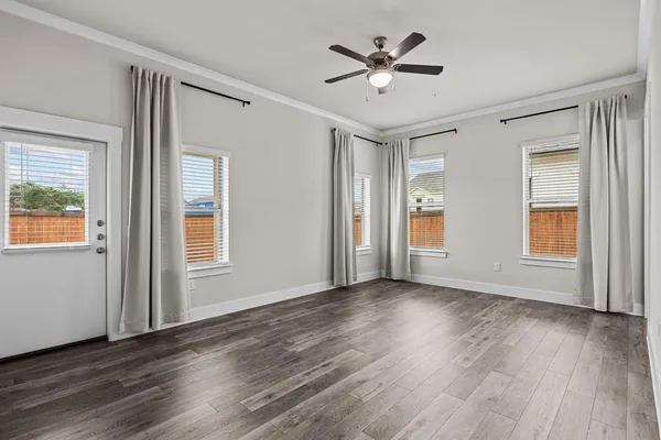wooden floor in an empty room with a window