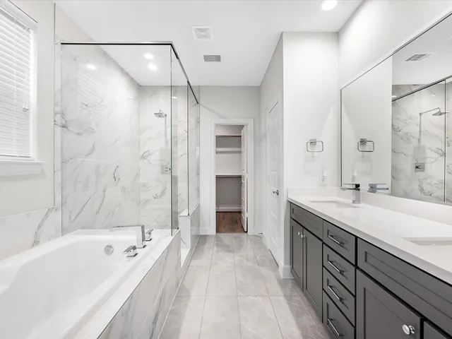 a spacious bedroom with a bed and wooden floor