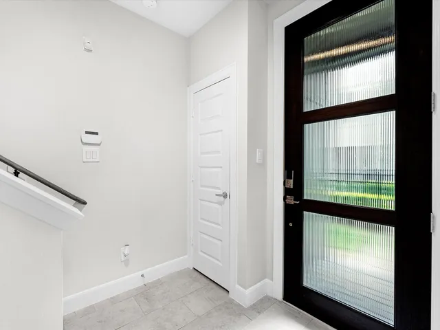 a view of a kitchen with white cabinets and sink