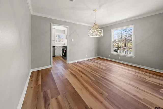 a view of livingroom with hardwood floor and kitchen view