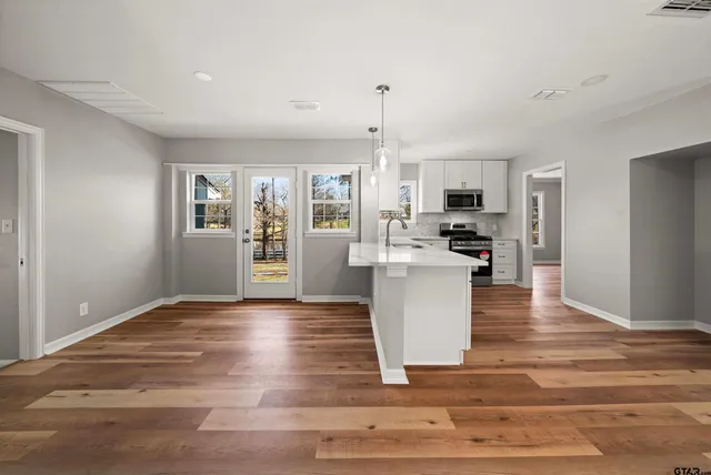 a view of a kitchen with microwave and cabinets
