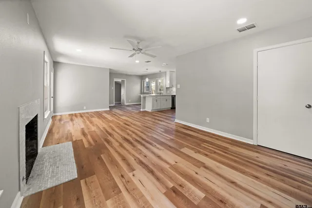 a spacious bathroom with a sink and a mirror