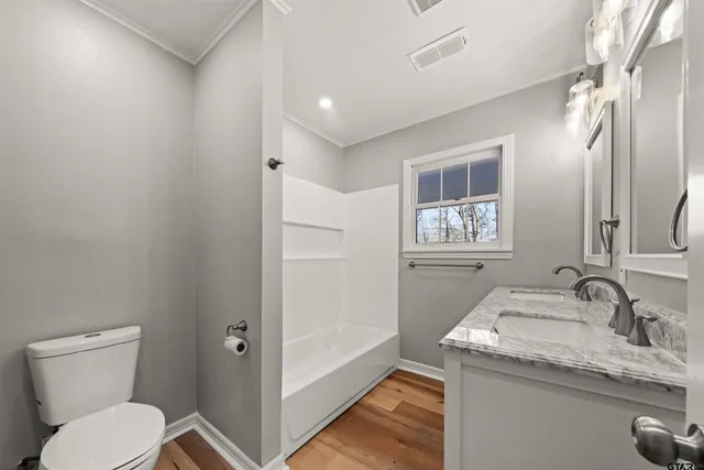 a bathroom with a granite countertop sink a mirror and a