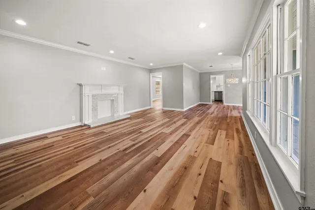 a view of a room with wooden floor and staircase