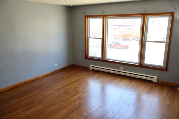a view of room with wooden floor and window