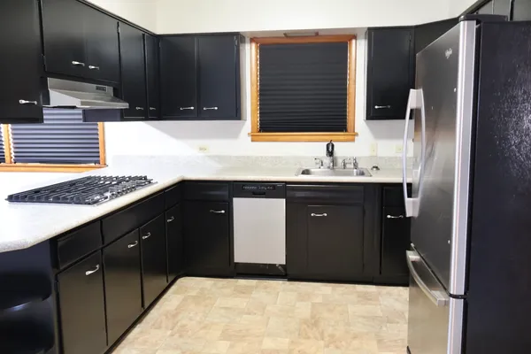 a kitchen with a sink and a wooden cabinets