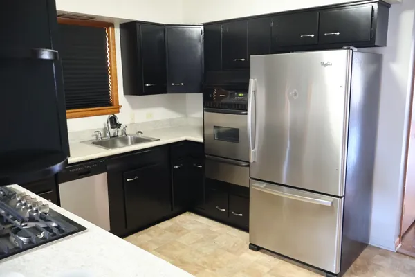 a kitchen with a refrigerator and a sink