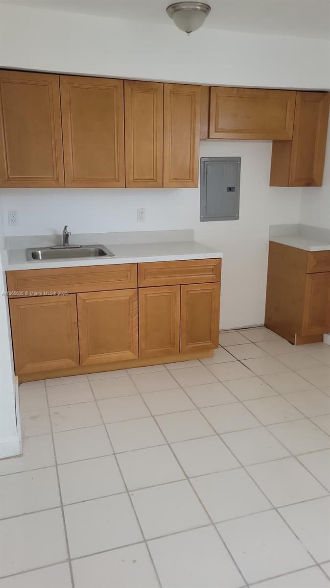 a kitchen with granite countertop a sink and a stove top oven