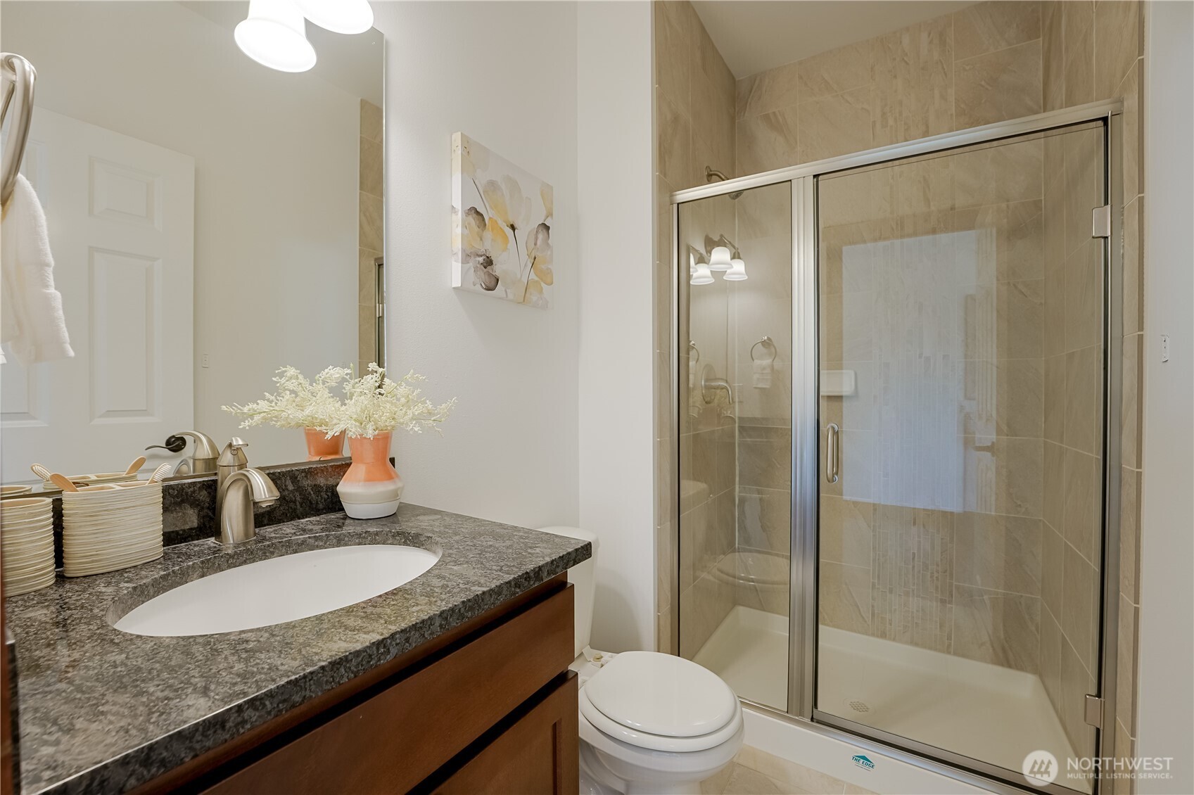 607 217th Street Southwest Bothell, WA 98021 - Photo 15 of 36 a bathroom with a granite countertop sink toilet and shower