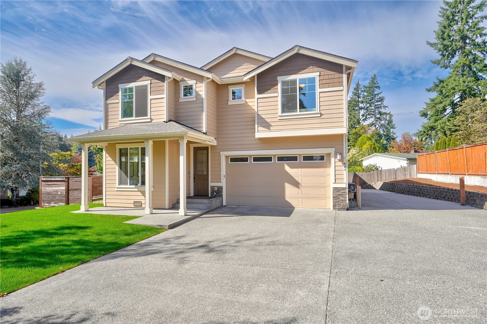 607 217th Street Southwest Bothell, WA 98021 - Photo 2 of 36 a front view of a house with a yard and garage