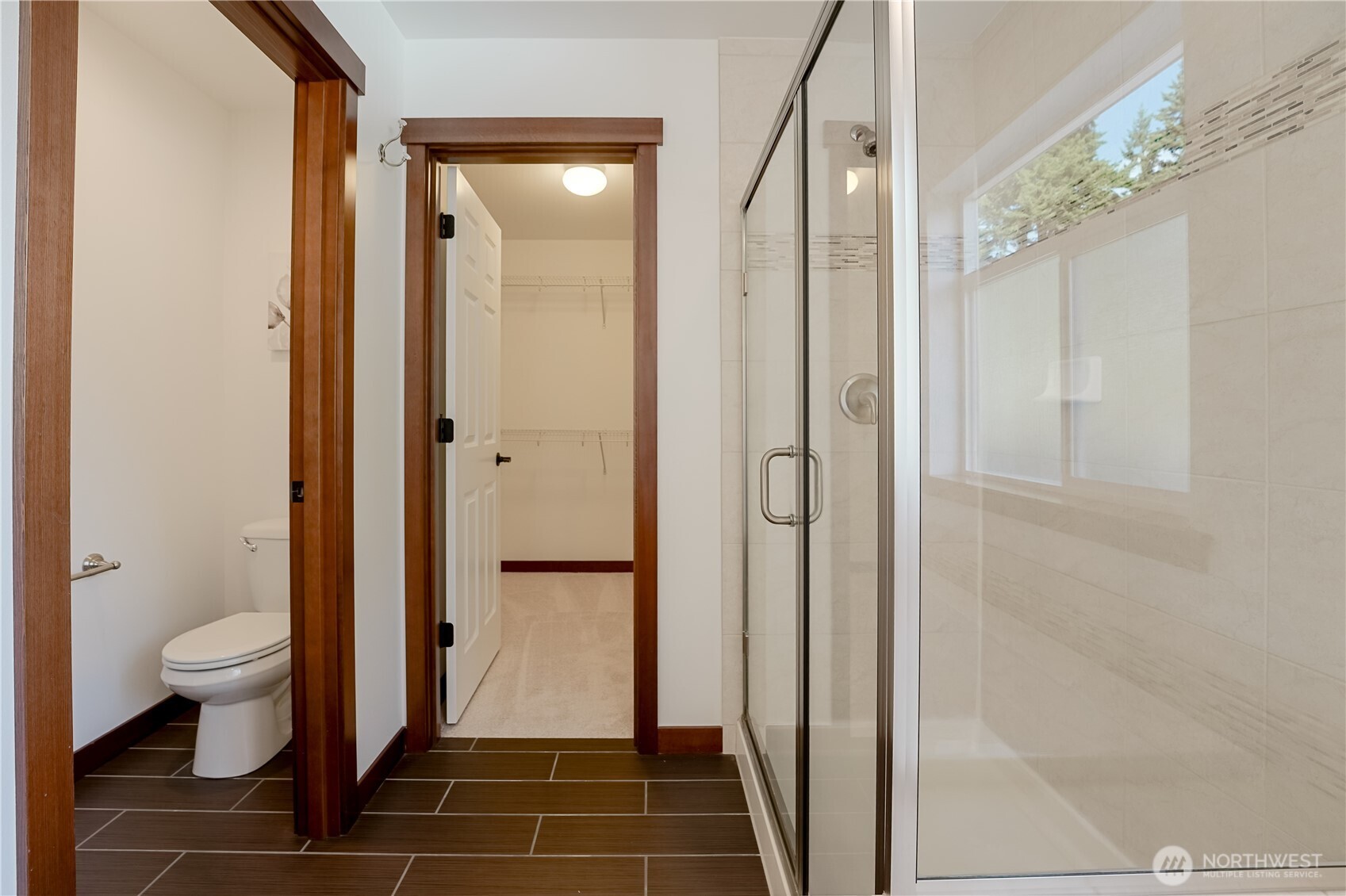 607 217th Street Southwest Bothell, WA 98021 - Photo 28 of 36 a bathroom with a glass door shower and a toilet