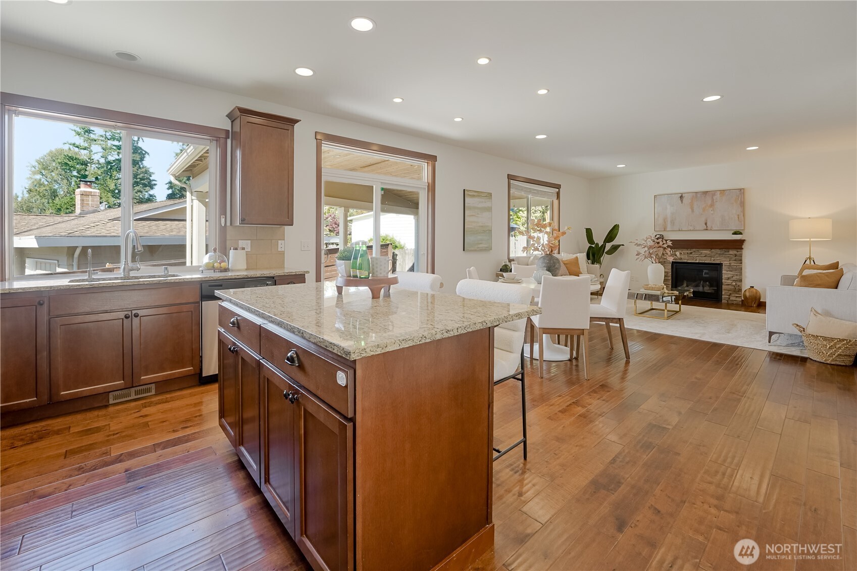 607 217th Street Southwest Bothell, WA 98021 - Photo 10 of 36 a kitchen with center island wooden floor and a sink