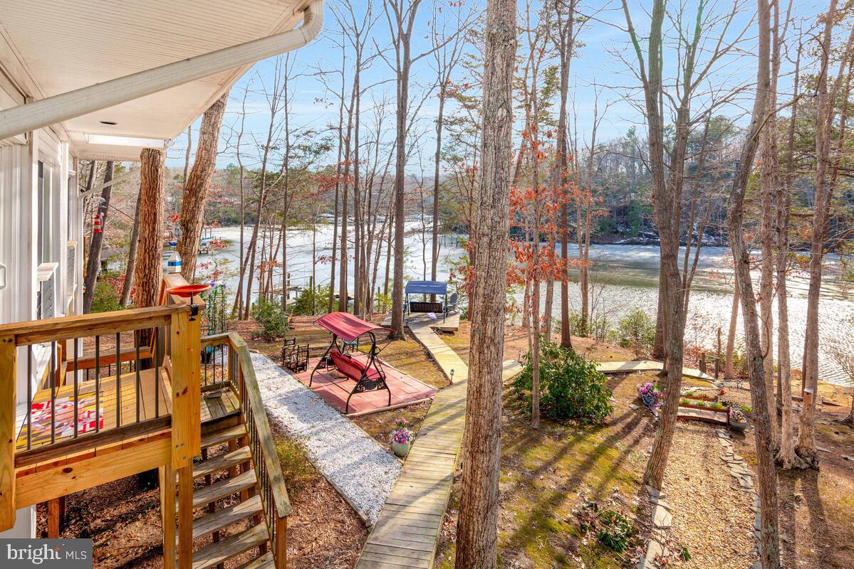 263 Frontier Trail Lusby, MD 20657 - Photo 47 of 94 a balcony with furniture and a potted plant