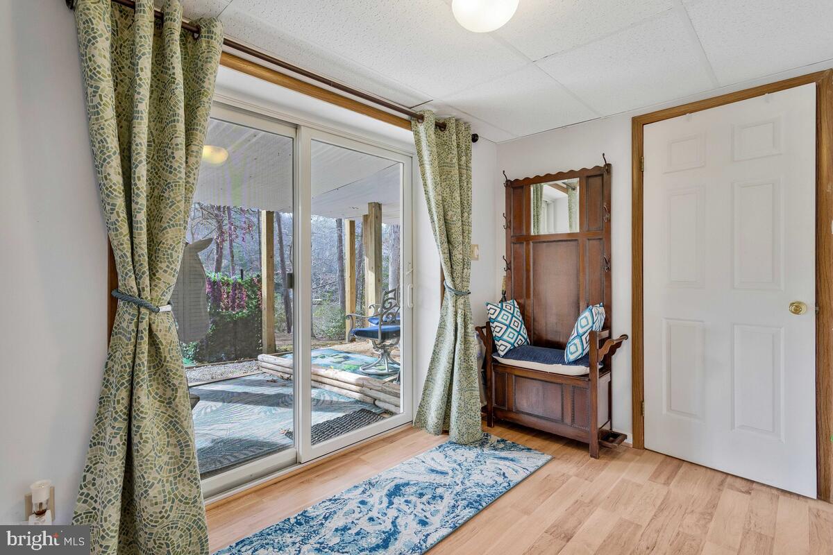 263 Frontier Trail Lusby, MD 20657 - Photo 60 of 94 a living room with furniture and a floor to ceiling window