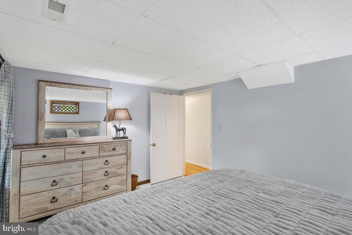 263 Frontier Trail Lusby, MD 20657 - Photo 76 of 94 a bedroom with a bed and a dresser in it