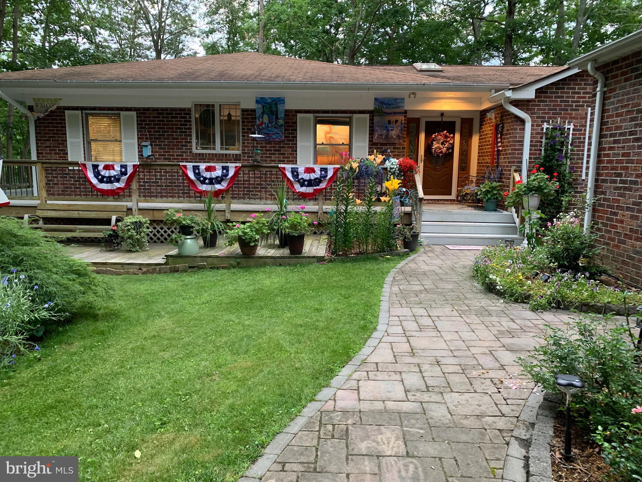 263 Frontier Trail Lusby, MD 20657 - Photo 87 of 94 a front view of house with yard and outdoor seating