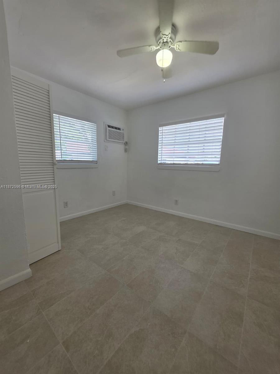 511 Northwest 4th Avenue, Unit 2 Hallandale Beach, FL 33009 - Photo 14 of 28 an empty room with a view of a ceiling fan