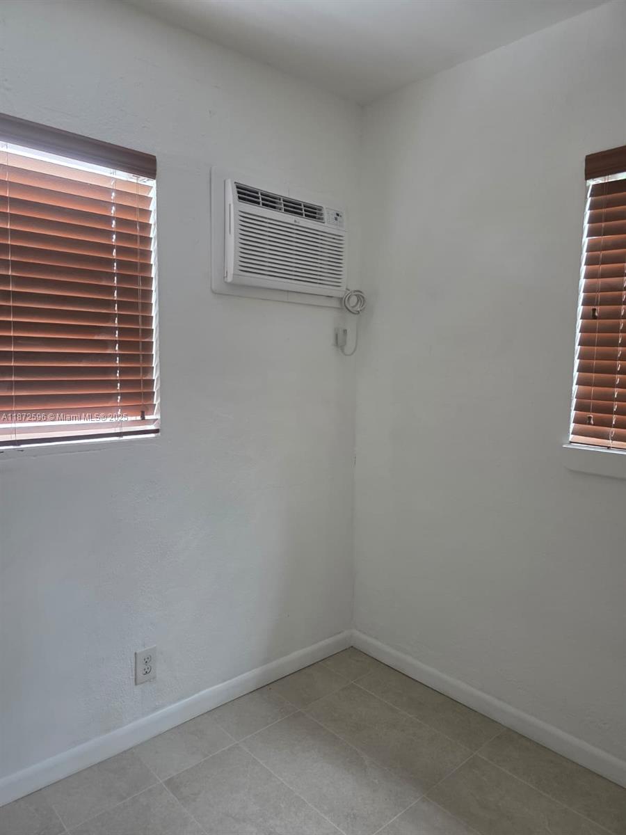 511 Northwest 4th Avenue, Unit 2 Hallandale Beach, FL 33009 - Photo 15 of 28 an empty room with windows