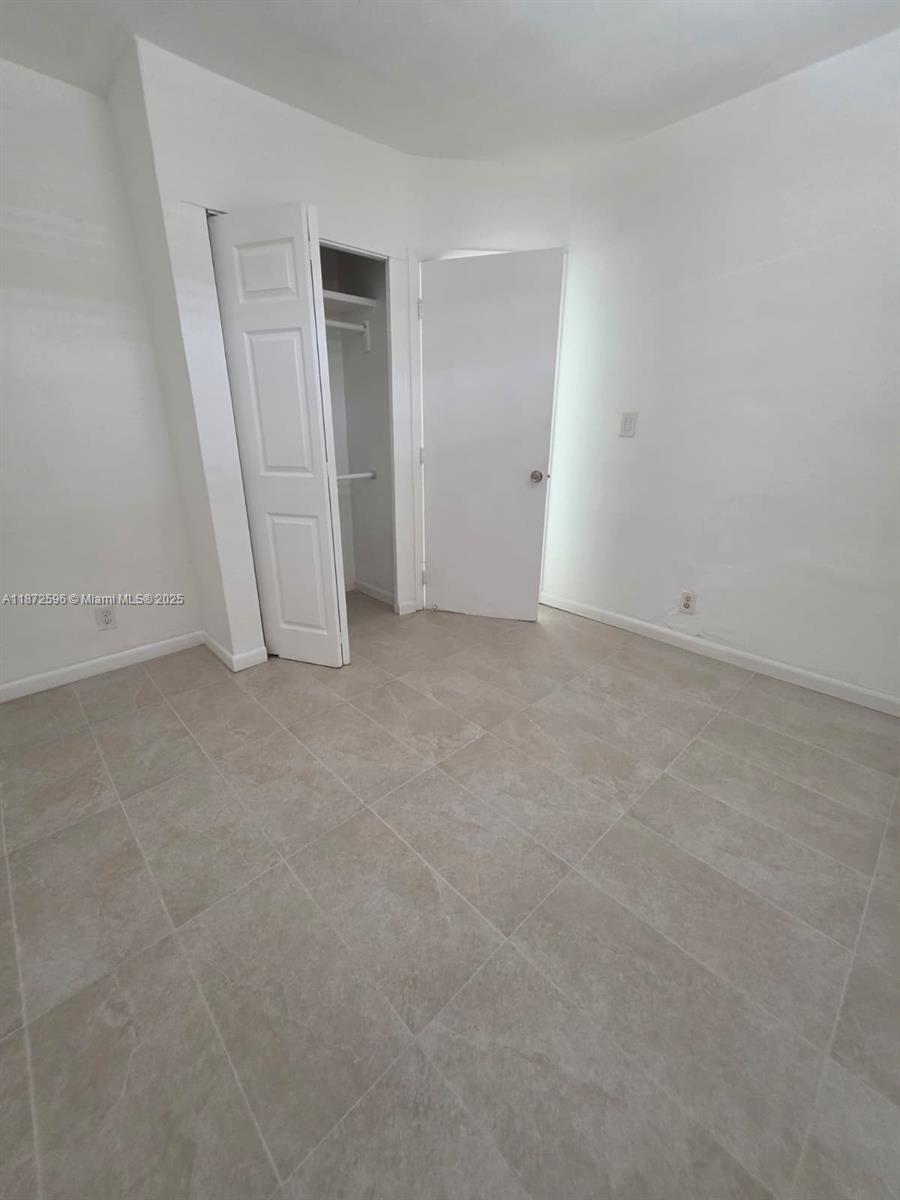 511 Northwest 4th Avenue, Unit 2 Hallandale Beach, FL 33009 - Photo 16 of 28 an empty room with closet