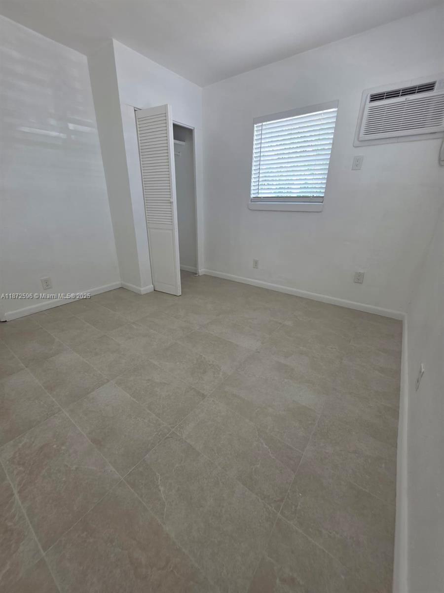 511 Northwest 4th Avenue, Unit 2 Hallandale Beach, FL 33009 - Photo 17 of 28 an empty room with windows