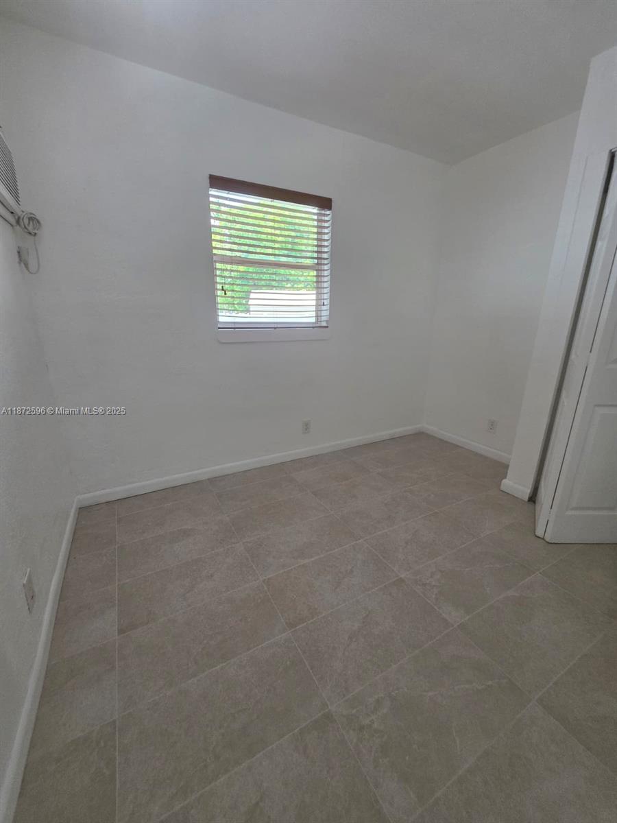 511 Northwest 4th Avenue, Unit 2 Hallandale Beach, FL 33009 - Photo 18 of 28 an empty room with windows