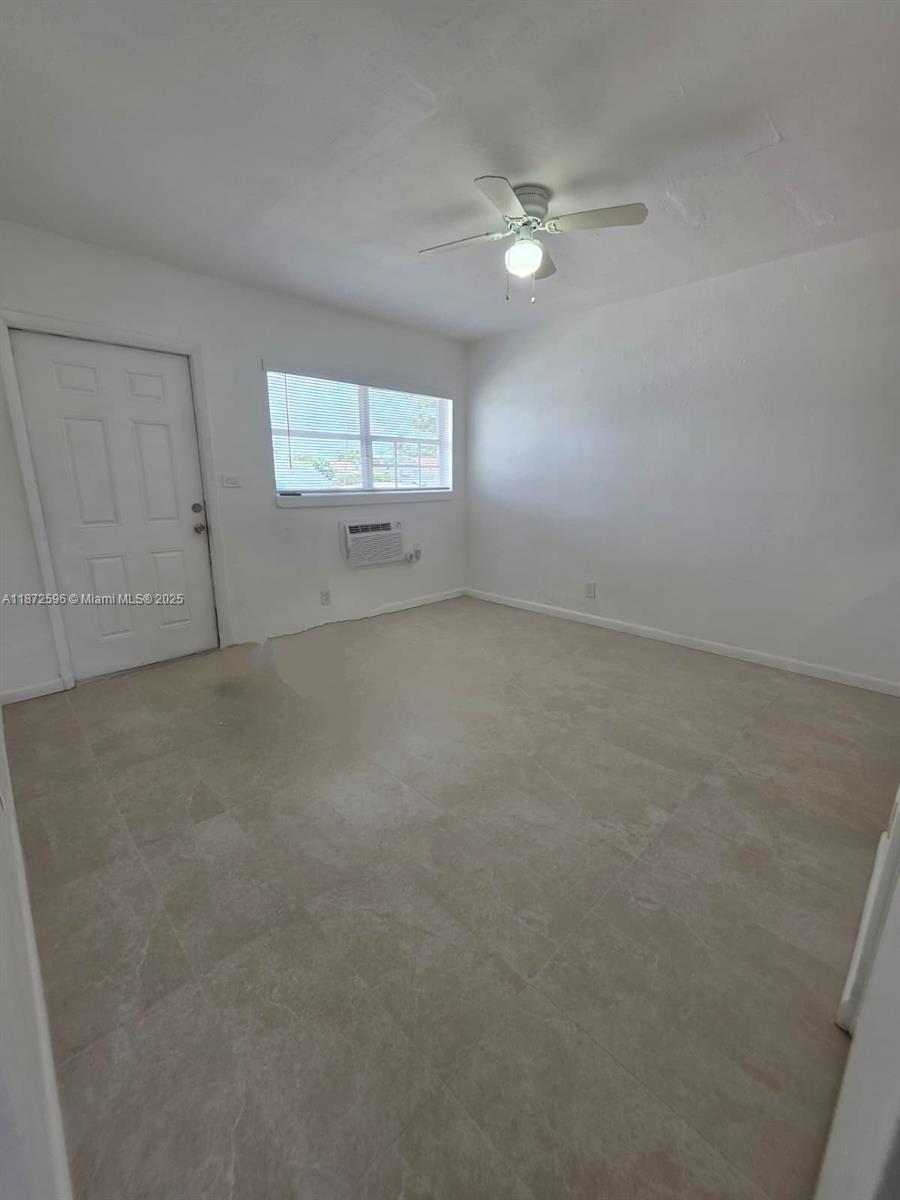 511 Northwest 4th Avenue, Unit 2 Hallandale Beach, FL 33009 - Photo 2 of 28 a view of an empty room with a window