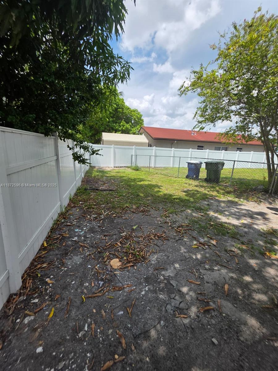511 Northwest 4th Avenue, Unit 2 Hallandale Beach, FL 33009 - Photo 26 of 28 a view of a house with a yard