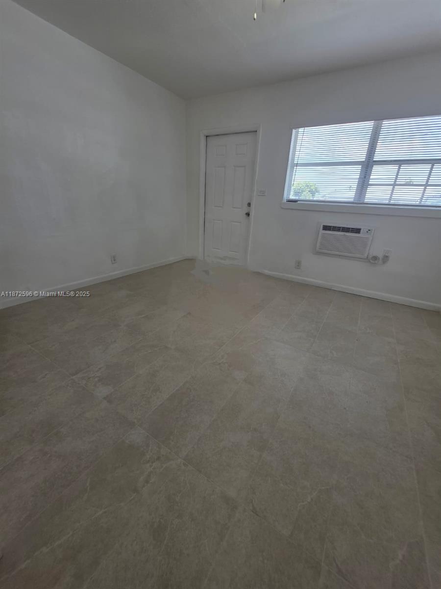 511 Northwest 4th Avenue, Unit 2 Hallandale Beach, FL 33009 - Photo 3 of 28 an empty room with a empty space and window