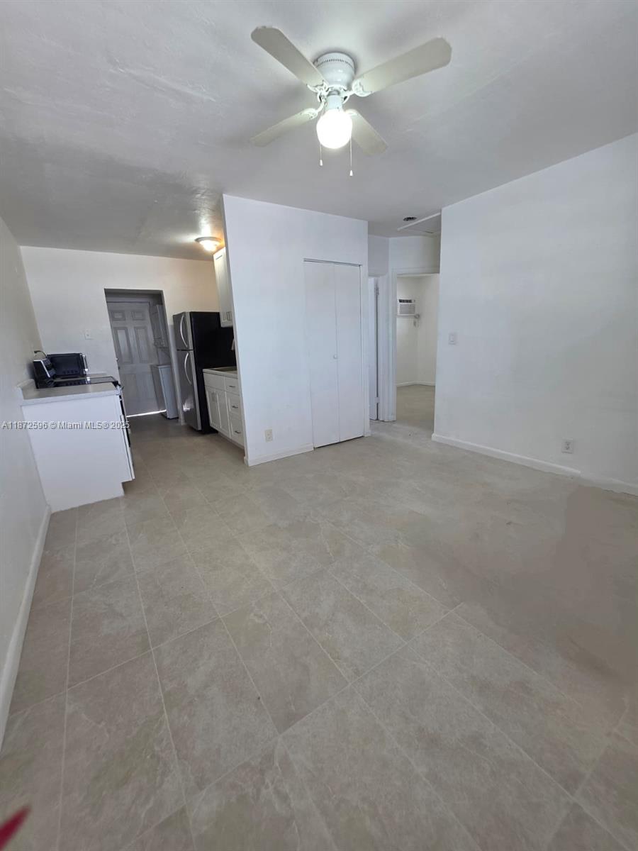 511 Northwest 4th Avenue, Unit 2 Hallandale Beach, FL 33009 - Photo 4 of 28 an empty room with a ceiling fan and a ceiling fan