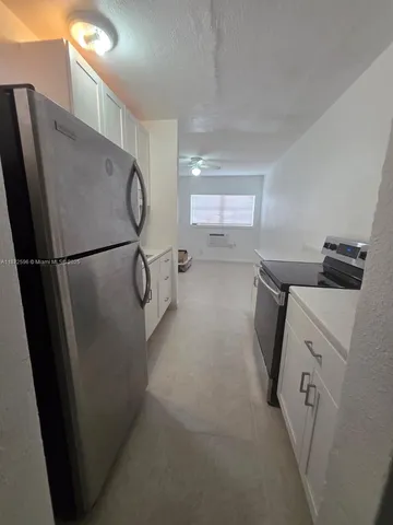 a utility room with cabinets washer and dryer