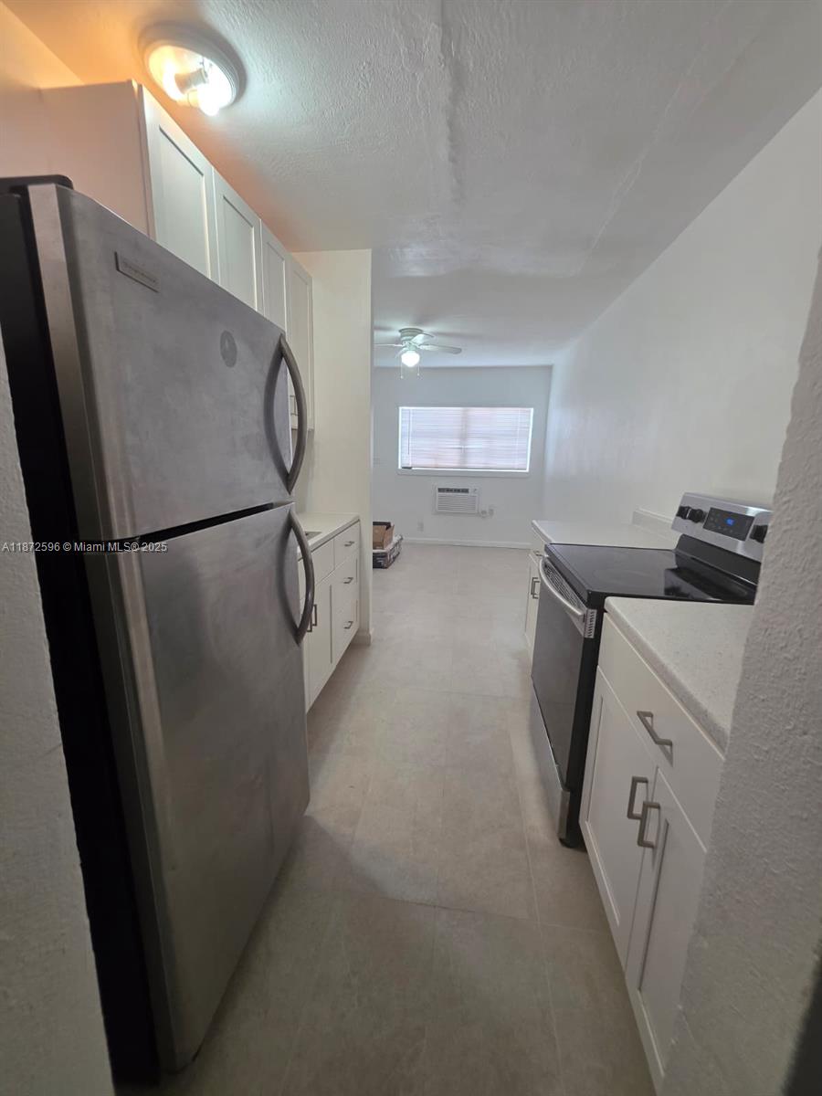 511 Northwest 4th Avenue, Unit 2 Hallandale Beach, FL 33009 - Photo 7 of 28 a utility room with cabinets washer and dryer