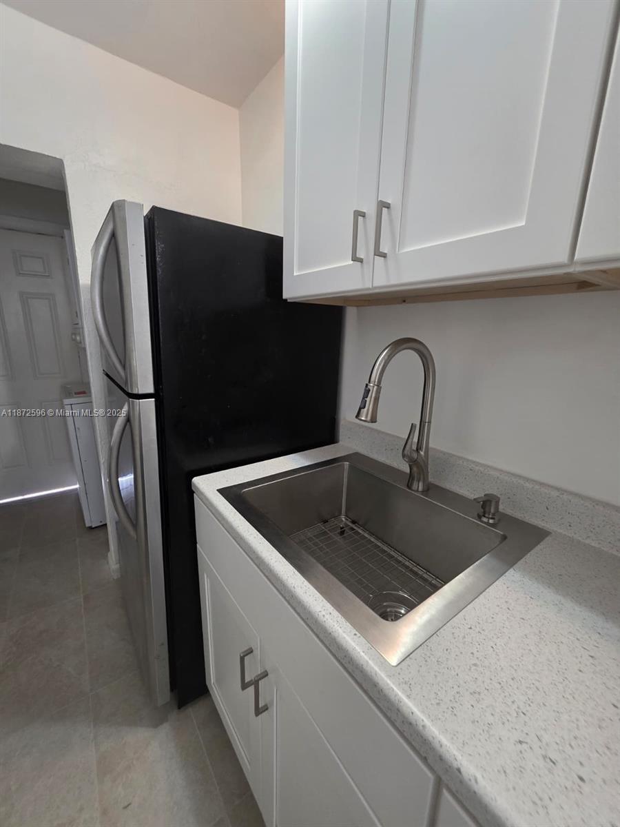 511 Northwest 4th Avenue, Unit 2 Hallandale Beach, FL 33009 - Photo 8 of 28 a kitchen with stainless steel appliances granite countertop a sink a refrigerator and a stove