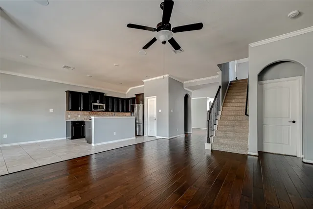 a view of empty room with wooden floor
