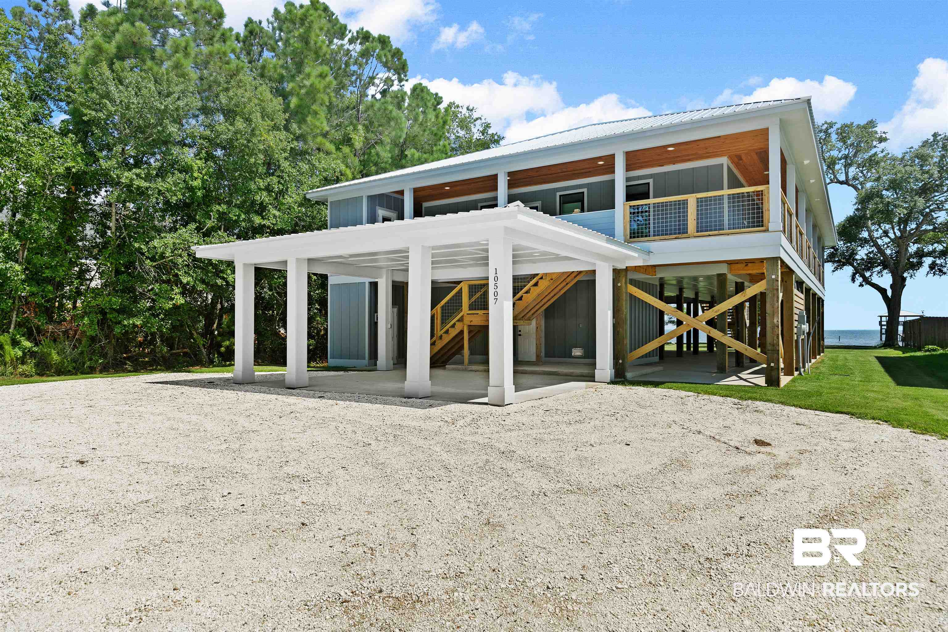 10507 County Road 1 Fairhope, AL 36532 - Photo 41 of 59 View of front of house featuring a carport, a balcony, and a front yard