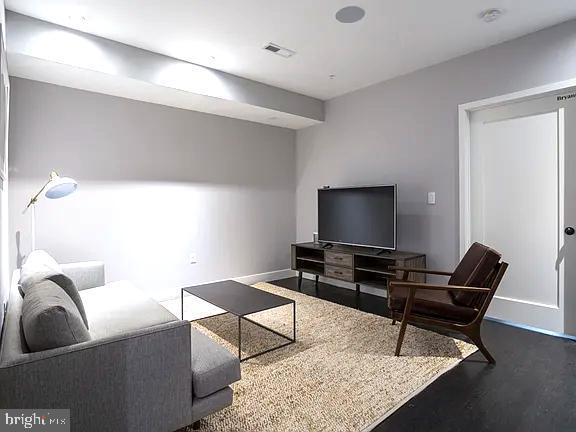 819 6th Street Northwest, Unit GEORGE Washington, DC 20001 - Photo 8 of 19 a living room with furniture and a flat screen tv