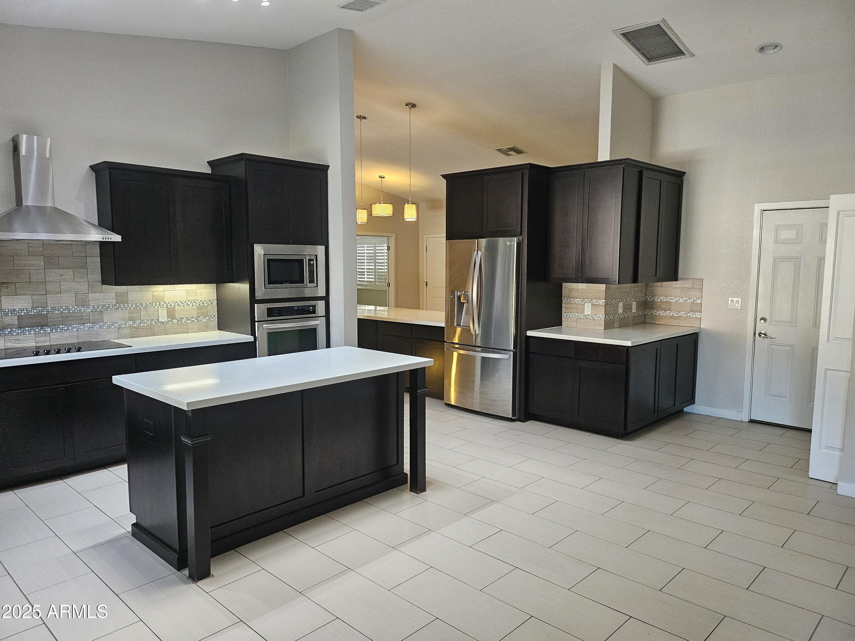 6002 East Marconi Avenue Scottsdale, AZ 85254 - Photo 11 of 29 a kitchen with stainless steel appliances a refrigerator and a stove