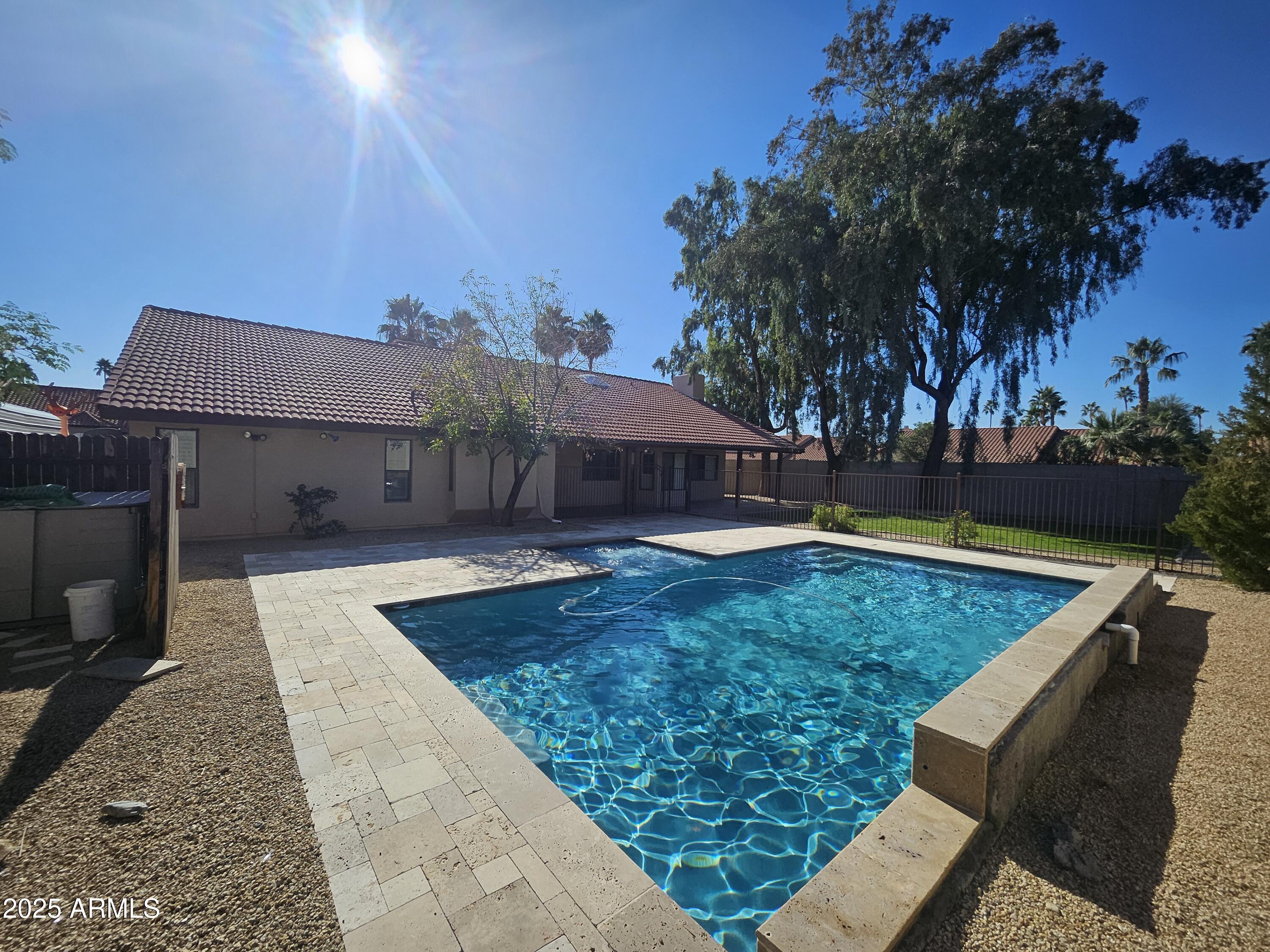 6002 East Marconi Avenue Scottsdale, AZ 85254 - Photo 29 of 29 a view of a swimming pool with a patio and a yard
