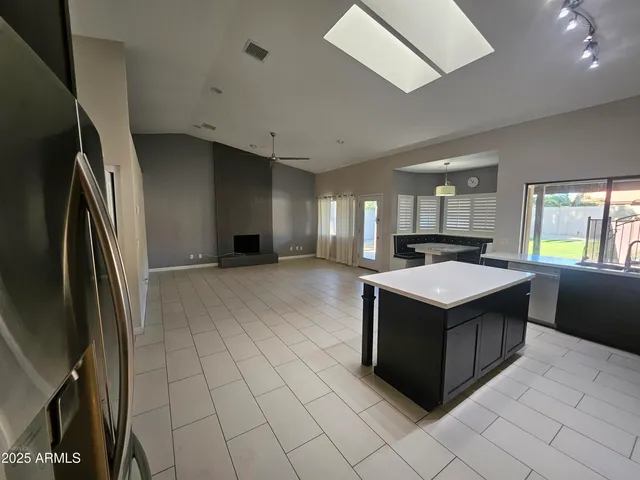 an empty room with windows and fireplace