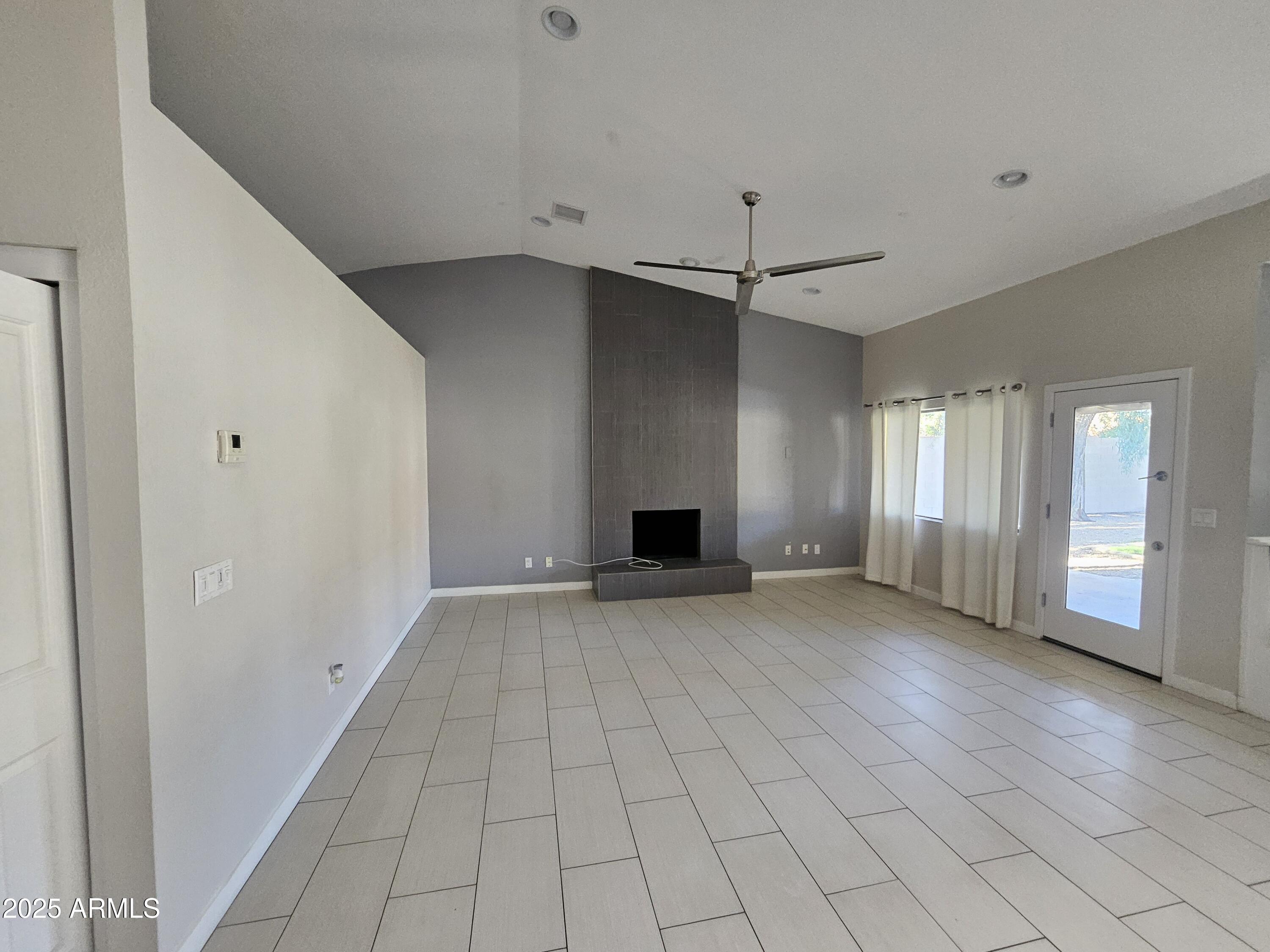6002 East Marconi Avenue Scottsdale, AZ 85254 - Photo 6 of 29 an empty room with windows and fireplace