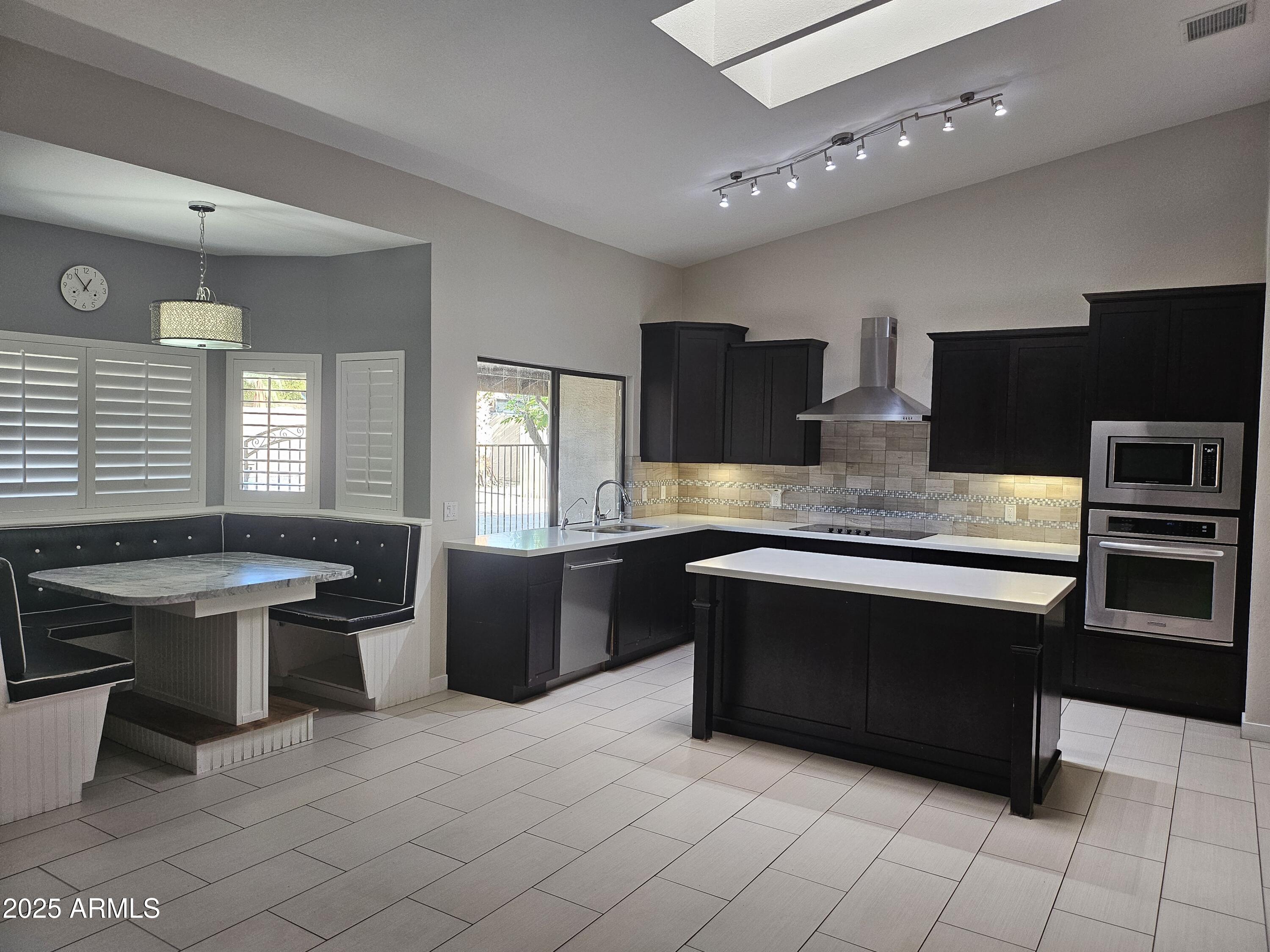 6002 East Marconi Avenue Scottsdale, AZ 85254 - Photo 8 of 29 a large kitchen with stainless steel appliances a stove a sink dishwasher and a refrigerator