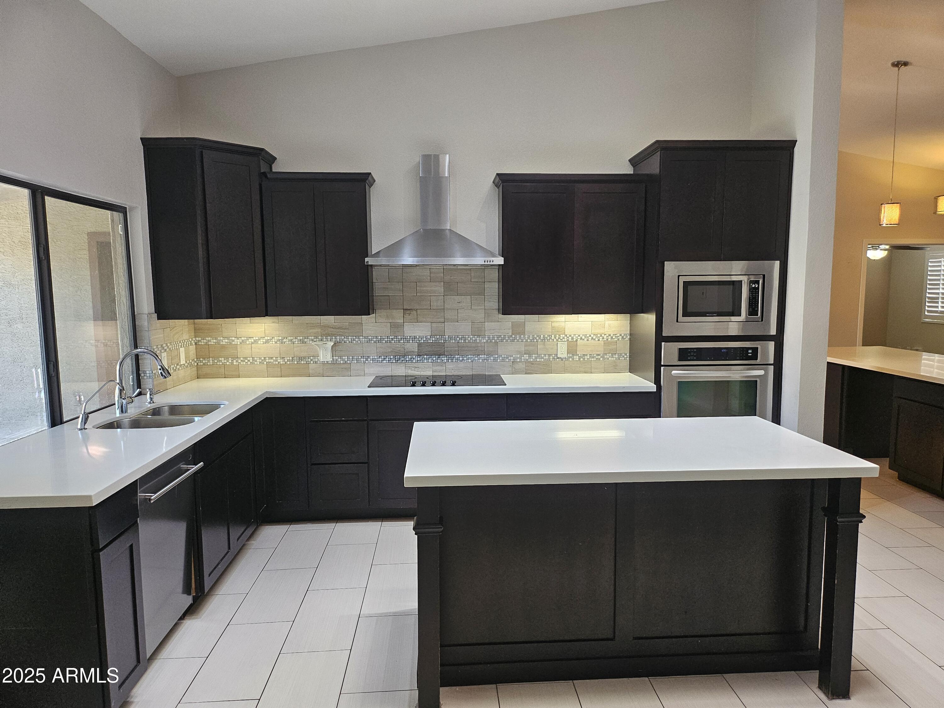 6002 East Marconi Avenue Scottsdale, AZ 85254 - Photo 10 of 29 a kitchen with a refrigerator and a sink