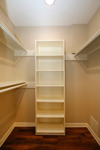 a view of walk in closet with empty racks
