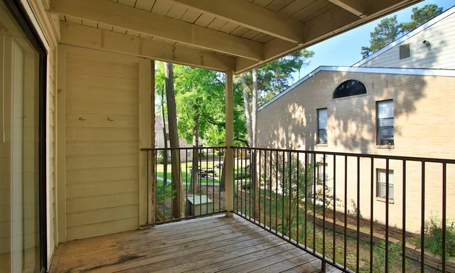a view of balcony with wooden floor