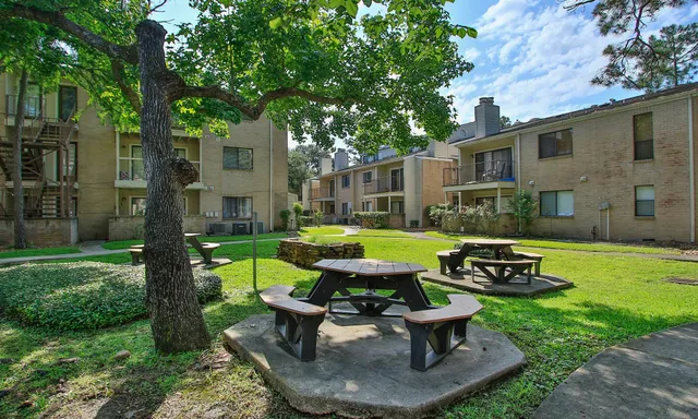 a view of a house with backyard sitting area and garden