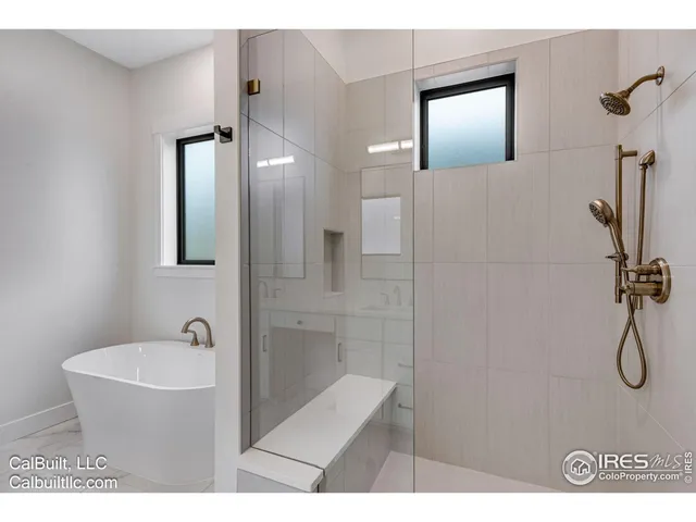 a bathroom with a bathtub and shower