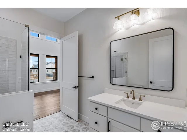 a bathroom with a sink a vanity and a mirror