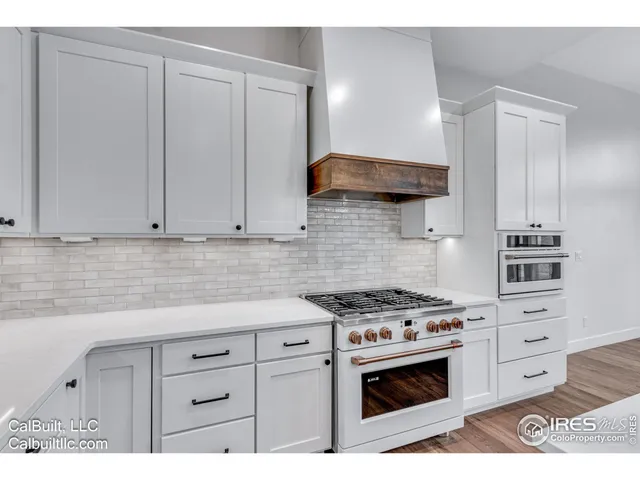 a kitchen with stainless steel appliances a stove a sink and a cabinets