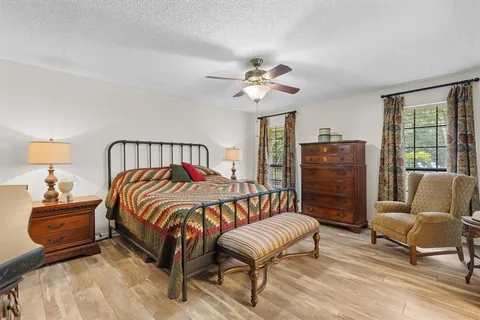 a bedroom with a bed a couch and dresser