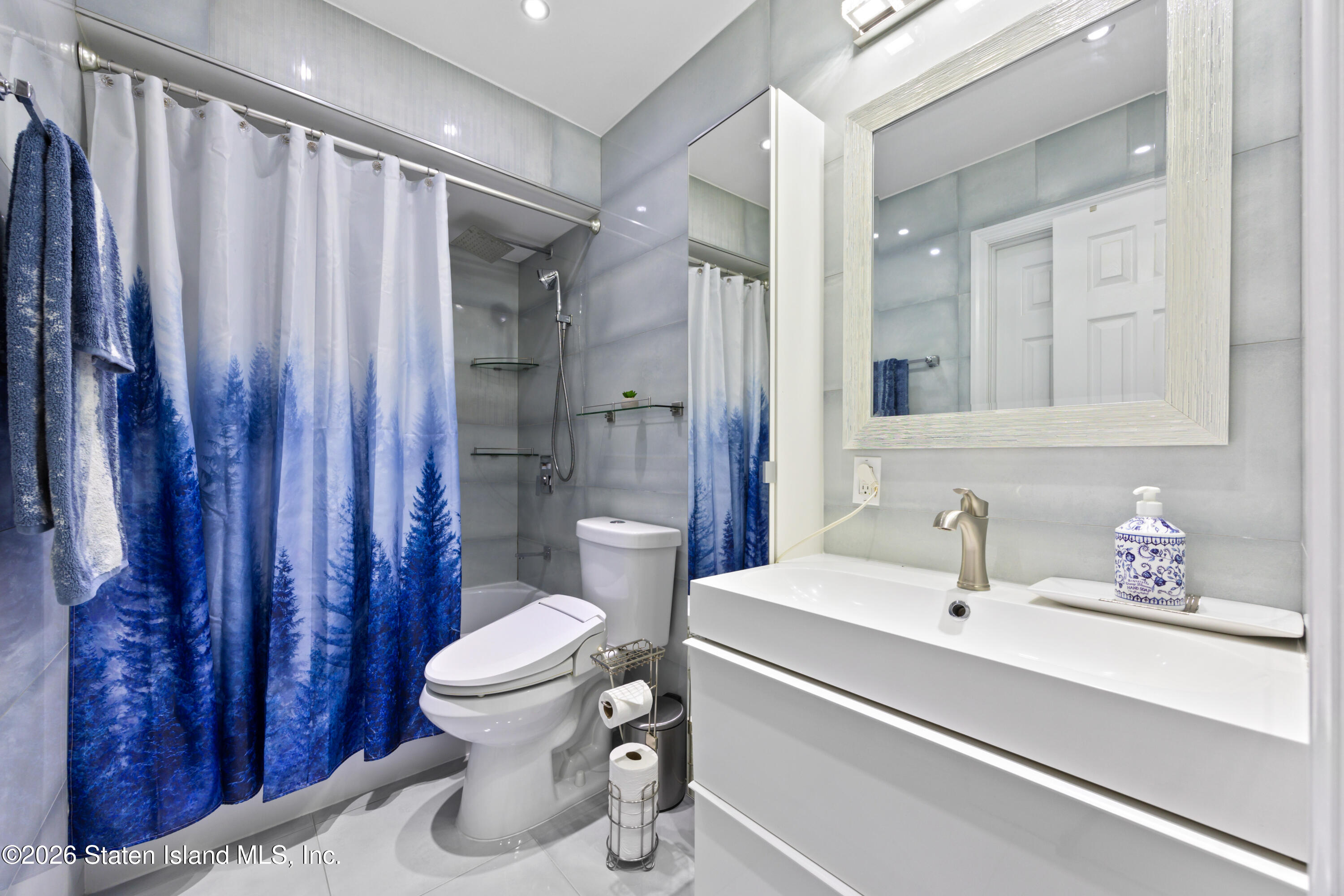 23 Stack Drive Staten Island, NY 10312 - Photo 14 of 29 a bathroom with a sink a toilet and shower